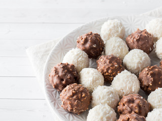 Chocolate and Coconut Candy on a Plate of White background