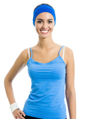 Young cheerful woman in fitness wear, isolated