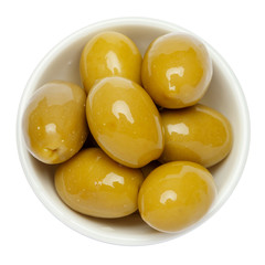 green olives in white bowl on white background