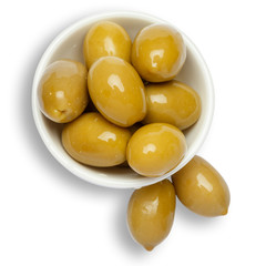 green olives in white bowl on white background