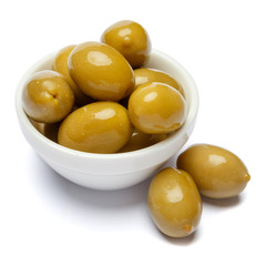 green olives in white bowl on white background