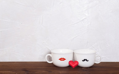 Valentine's day holiday celebration with hearts and cups over bokeh background