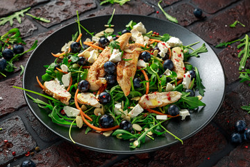 Fresh Chicken salad with Blueberries, feta, carrots, nuts and green vegetables. healthy food concept