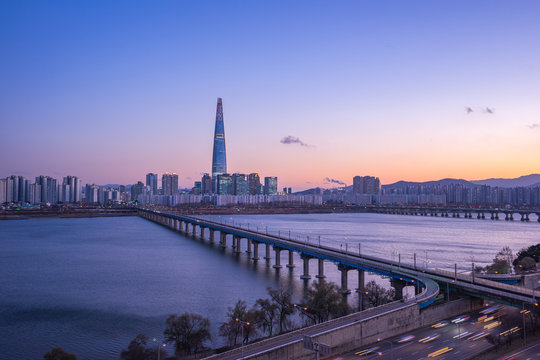 Han River at twilight with view of Seoul city skyline in South Korea
