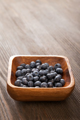 ripe sweet blueberries on wooden table