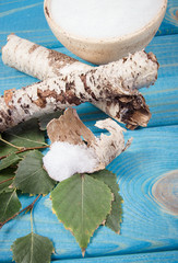 Xylitol - sugar substitute. Birch sugar on blue wooden background.