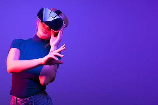 Woman Touching A Virtual Button With VR Set On Her Head