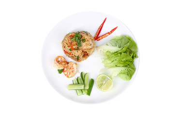 Fried rice with shrimp topped sliced red hot chili pepper,sliced cucumber ,halved green lemon and garlic on white plate.