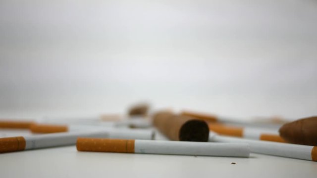 Spinning generic cigarettes and cigars spinning over white  ALT