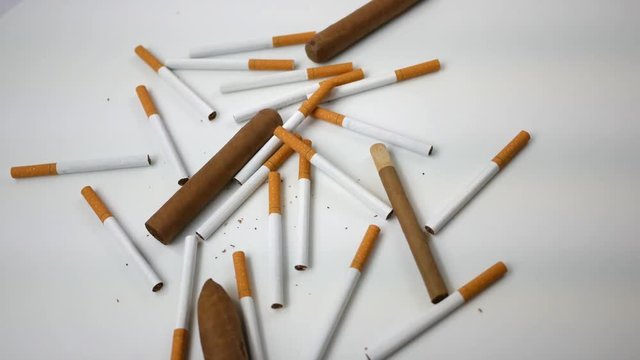 Spinning generic cigarettes and cigars spinning over white  - Overhead Version