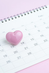 Fototapeta na wymiar Calendar with cute pink heart shape on 14 February on pink background using as romantic Valentines day concept