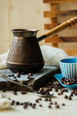 Coffee cup and metal turk on burlap background