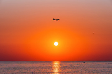 Fototapeta na wymiar Summer. Sea. Sunset on the Black sea. Sochi. Krasnodar Krai. Russia. The plane in the sky.