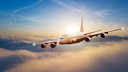 Fototapeta na wymiar Huge commercial airplane flying above clouds