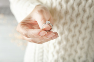 Woman holding luxury engagement ring, closeup