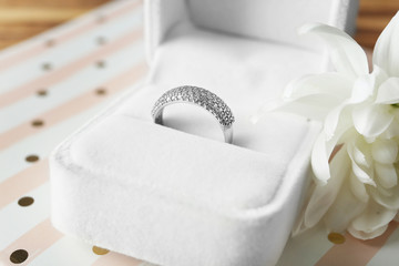 Fototapeta na wymiar Box with luxury engagement ring on table, closeup