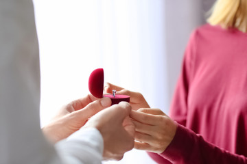 Obraz premium Man proposing to his beloved with beautiful engagement ring, closeup