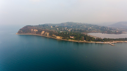 Aerial view of cliffs raising above sea.