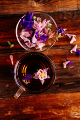 Obraz na płótnie Canvas Calendula tea with calendula flowers on a wooden table