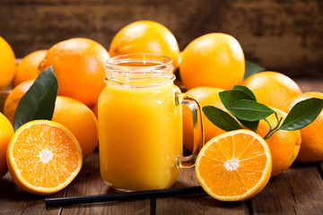 glass jar of fresh orange juice with fresh fruits