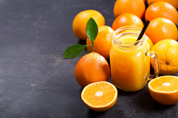 Obraz na płótnie Canvas glass jar of fresh orange juice with fresh fruits