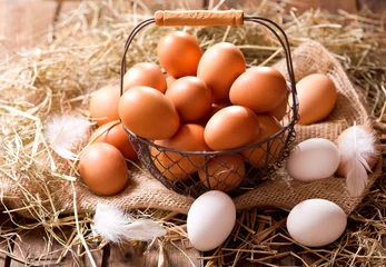 Tuinposter fresh eggs in a basket © Nitr