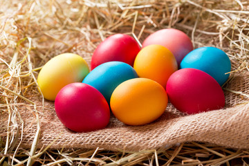 Fototapeta na wymiar Colorful Easter eggs in a hay
