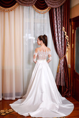Fototapeta premium The beautiful young woman posing in a wedding dress