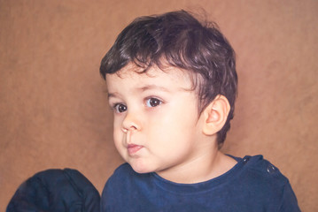 portrait of a cute little boy with dark hair