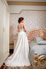 Fototapeta na wymiar Fashion bride in gorgeous wedding dress studio portrait.