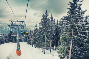 The cabins of ski lifts leading to ski resort in Bukovel, the heart of the snow-capped Carpathians Mountains in Ukraine. Amazing winter landscape. Gorgeous panoramic view.