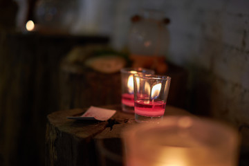 Candles placed on the timber. subject is blurred and low key.