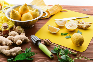 lemon and ginger with mint and honey. on a wooden background in a rustic style.