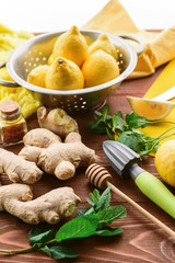 lemon and ginger with mint and honey. on a wooden background in a rustic style.