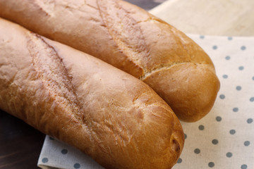 French baguette on the kitchen table. Close-up. Selective focus.