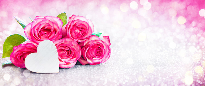Romantic background with bouquet of pink roses and heart
