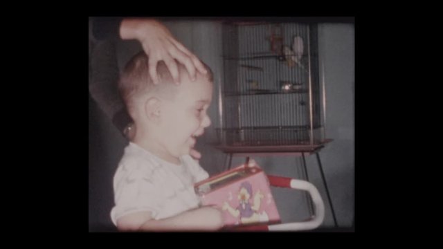 1961 2 year old little boy plays with jack in the box