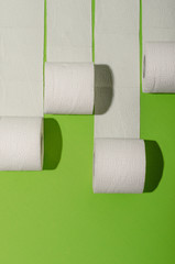 Toilet paper concept on green background. Hygiene and health. Concept photo.