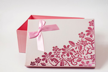 Open pink gift box with ribbon bow, isolated on white