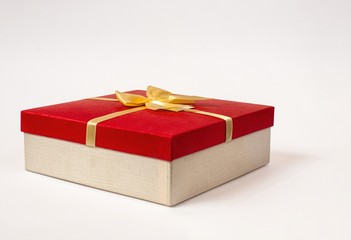 red gift box with gold ribbon bow, isolated on white