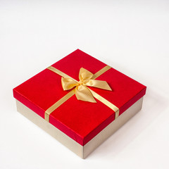 red gift box with gold ribbon bow, isolated on white