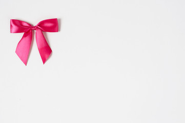 Beautiful pink ribbon bow on white background