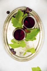 Wine and grapes over grey marble background