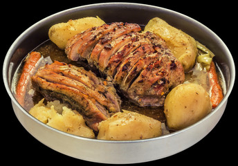 Seasoned Cut Pork Ham Chunks Stuffed With Bacon Oven Baked In Round Casserole Dish With Whole Red Potatoes And Carrots In Natural Gravy Isolated On Black Background
