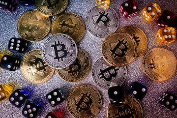 business ideas concept with bitcoin and colorful dice gambling risk currency on silver texture background financial market