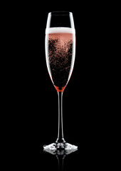 Rose pink champagne glass with bubbles on black