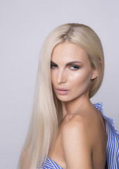 Sexy shoulder with soft tanned skin. Platinum blonde straight hair.