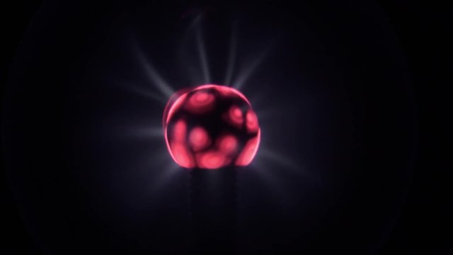 Lit electric tesla coil ball, with blue energy light rays moving, black background and a red, pink and purple center. Can be trimmed for seamless looping, closeup