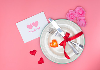 Valentines day table setting with plate On pink background
