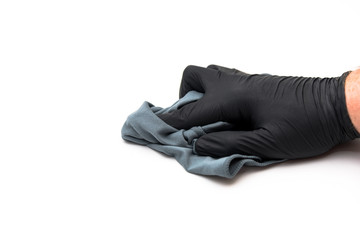 isolated hand with microfiber cloth and black disposable glove